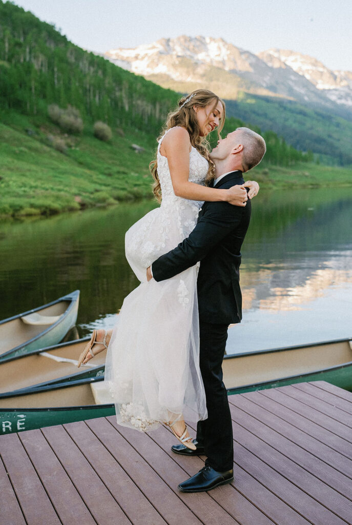 couple hugging on the dock at their Piney River Ranch wedding